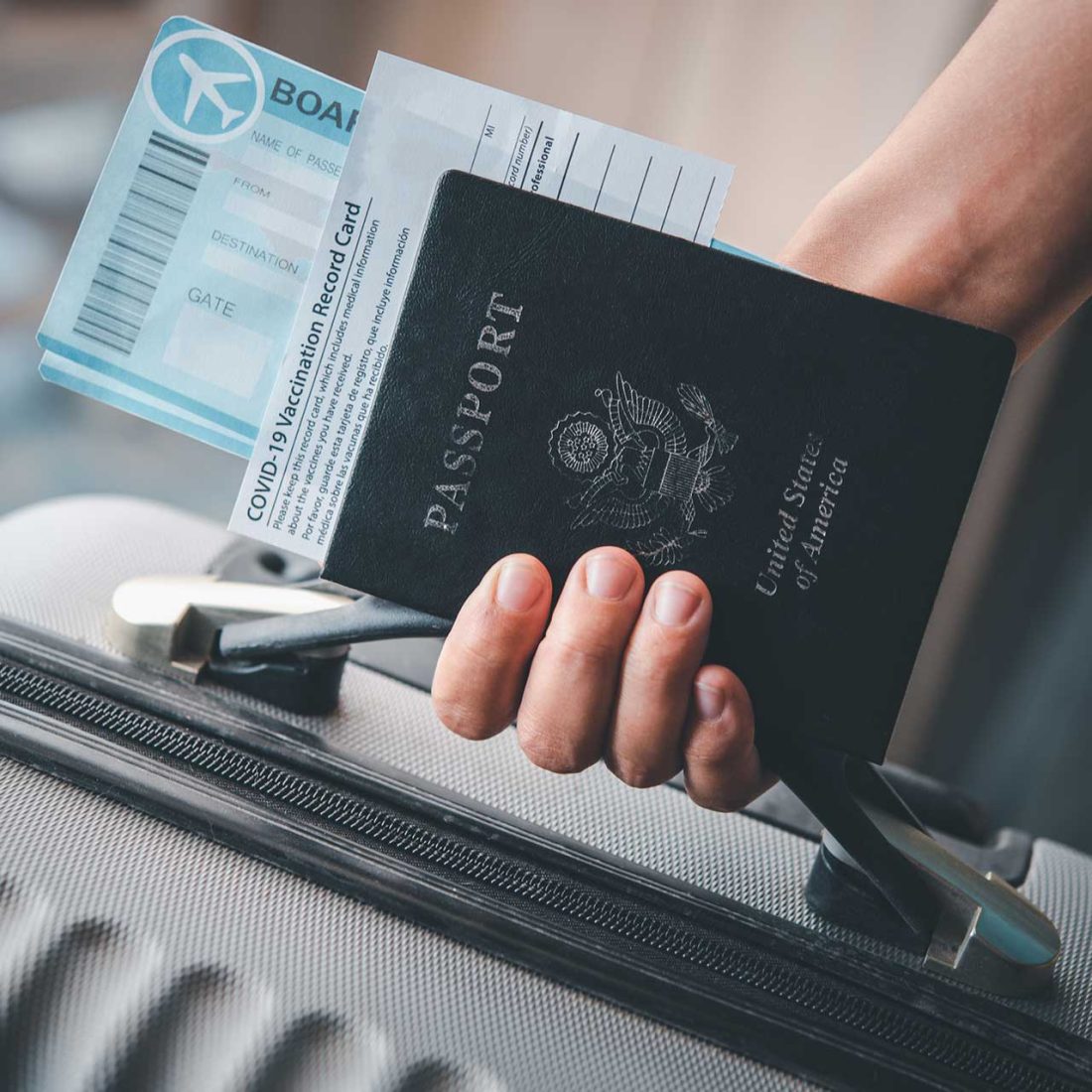 man holding passport and suitcase