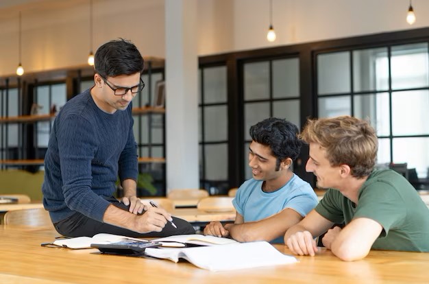 serious teacher checking assignment two students