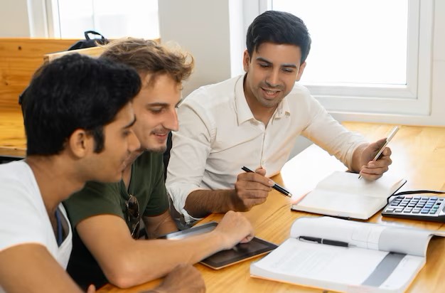 young teacher telling two students about corporate budgeting